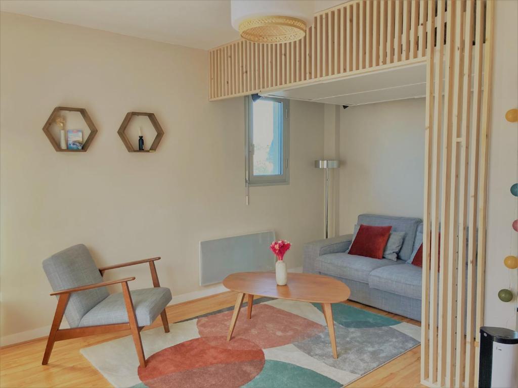多维尔Studio proche plage balcon et parking的客厅配有沙发和桌子