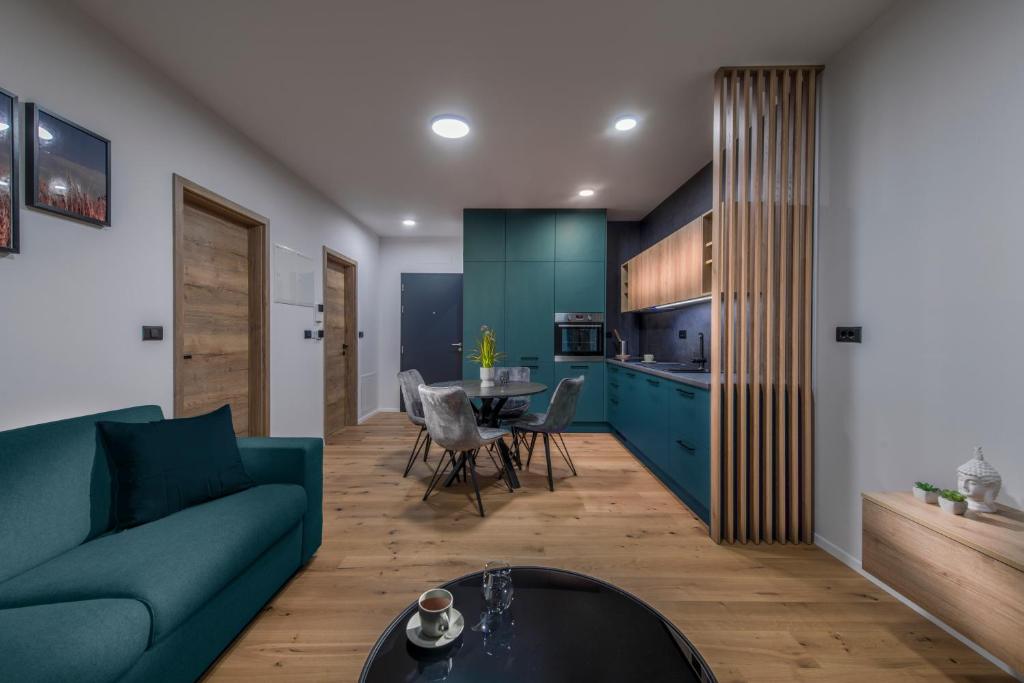 斯洛文尼亚格拉代茨Apartmaji Harpf的客厅配有蓝色的沙发和桌子