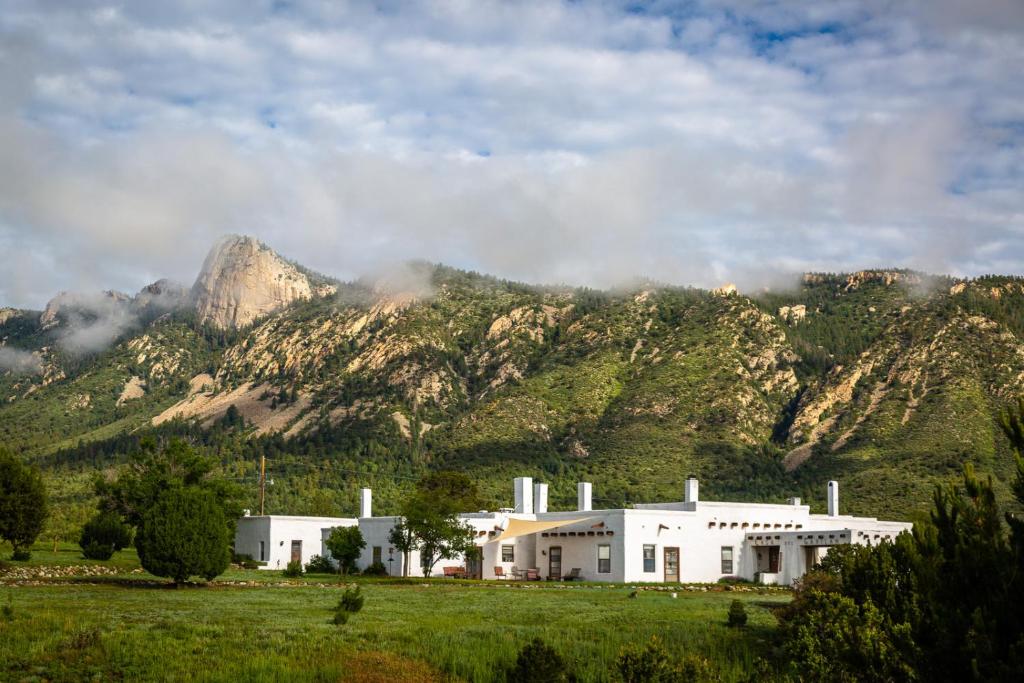CimarronCasa del Gavilan Historic Inn的山前的白色大建筑