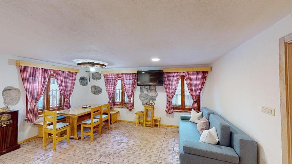 拉特西hiša Margit, Rateče 150的客厅配有蓝色的沙发和桌子