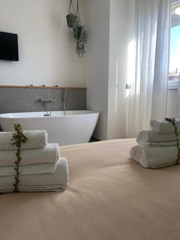 桑格罗堡Atmosphera home的浴室配有带毛巾和浴缸的床。