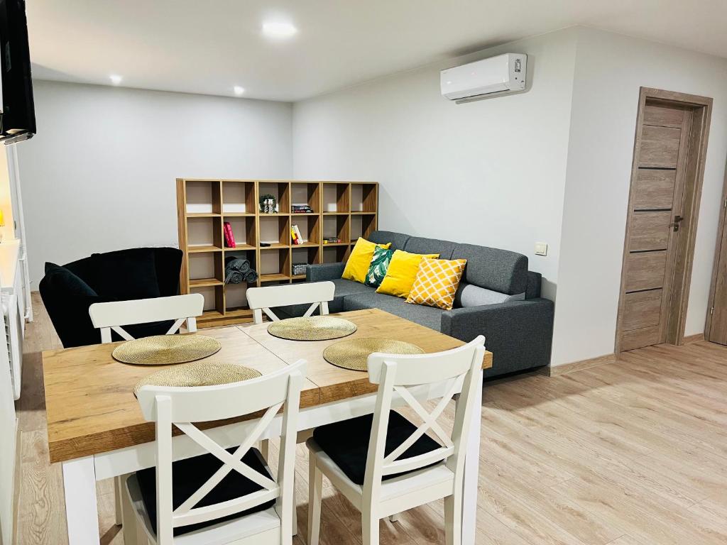 特拉凯Saulėti apartamentai Trakuose/Sunny apartment in Trakai的客厅配有桌椅和沙发