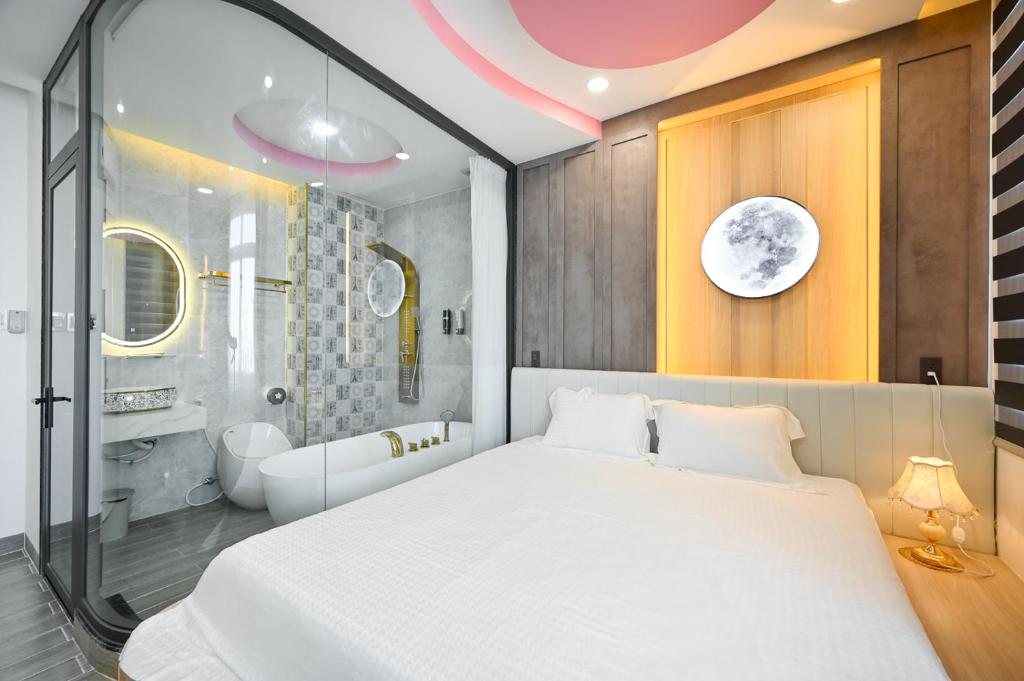 胡志明市Lotus Airport Hotel Saigon的一间带白色大床的卧室和一间浴室