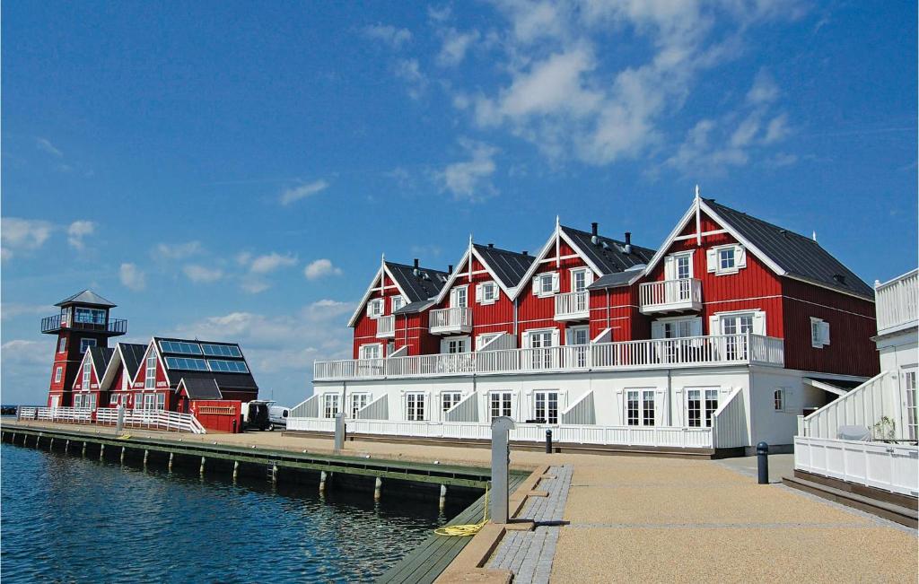 巴恩科普Pet Friendly Apartment In Bagenkop With Harbor View的水边的一座红色和白色的大建筑