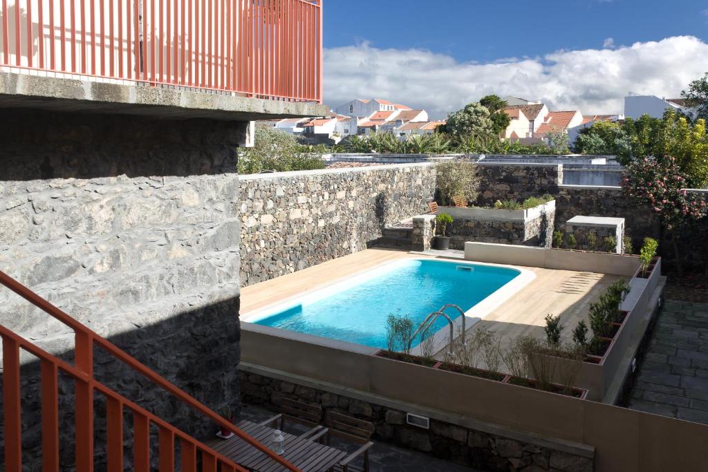 蓬塔德尔加达Azorean Urban Lodge的建筑物一侧的游泳池