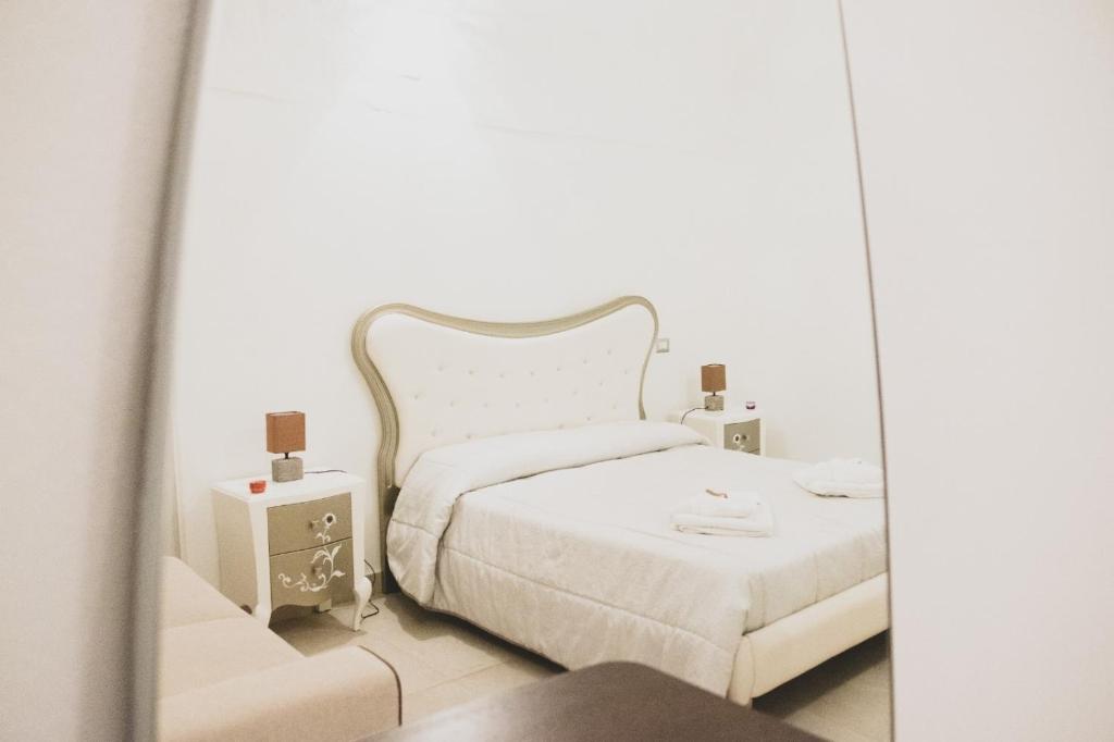 马泰拉Acasadifelice的白色卧室配有床和镜子