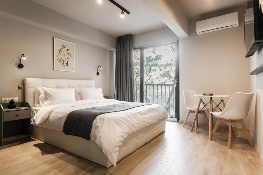 比雷埃夫斯WYZ Piraeus的一间卧室配有一张床、一张桌子和一个窗户。