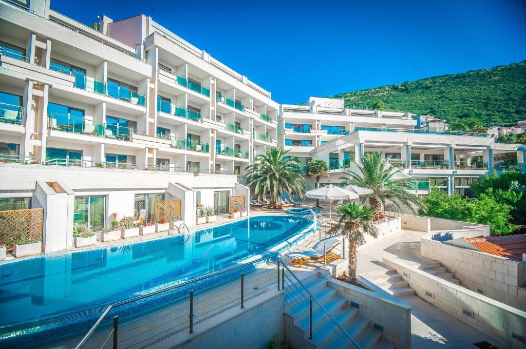 佩特罗瓦纳莫鲁蒙特卡萨健康及SPA酒店的一座大建筑前的游泳池