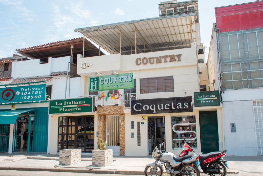 皮乌拉Hotel Country Boutique的停在商店大楼前的摩托车