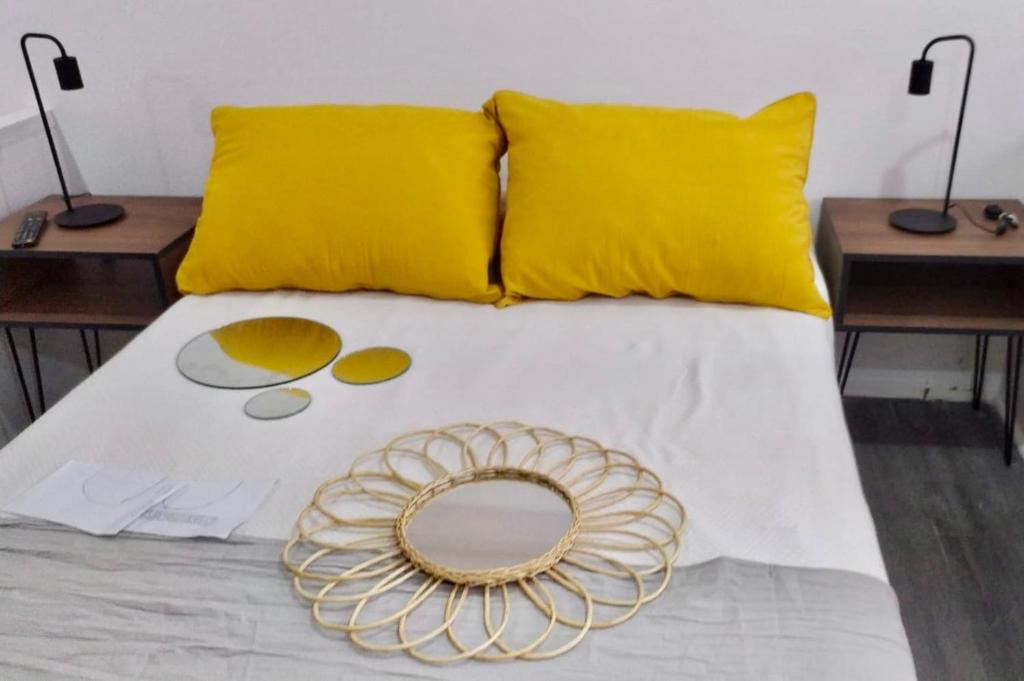 布宜诺斯艾利斯Montañeses 2830 Duplex Flat的一张带黄色枕头的床,上面有金板
