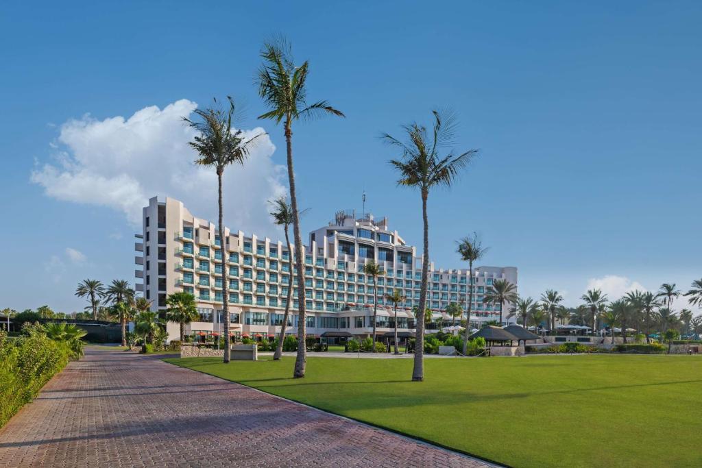 迪拜JA The Resort - JA Beach Hotel的公园前种有棕榈树的度假胜地