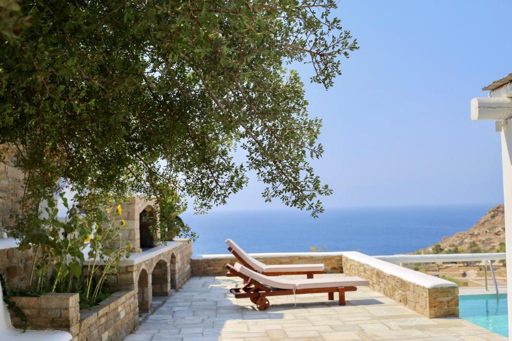 伊奥斯乔拉Villa Giulia, seaview villa的几个长凳坐在游泳池旁