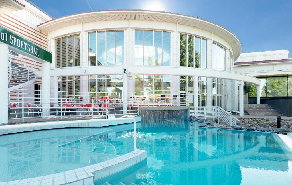 沃卡蒂卡提库塔假日俱乐部酒店的建筑前的一座带游泳池的建筑