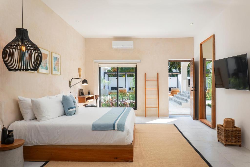 科苏梅尔Illa Cozumel的一间卧室设有一张床和一个滑动玻璃门