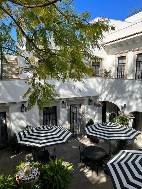 圣米格尔-德阿连德Casa Laní Luxury B&B的建筑物前的两把黑白雨伞