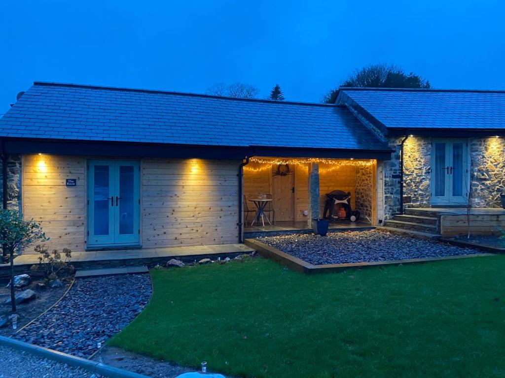普里茅斯Rural Retreat in Devon的一座带庭院的房屋和一座带灯光的房屋