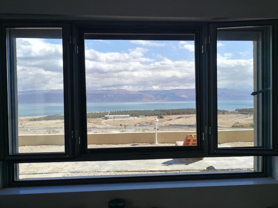 OvnatCharming unit in Dead Sea的享有海滩和海洋景致的窗户。