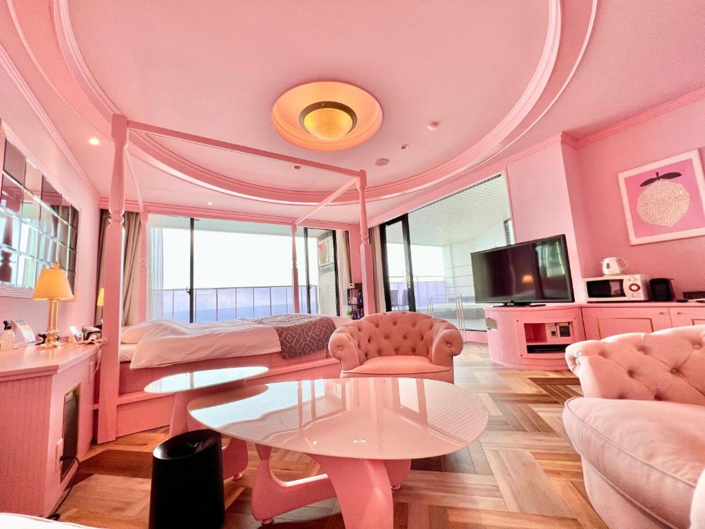 别府SKY Tower Sweet 4 Beppu, Resort Love Hotel的粉红色的客房配有一张床和一张桌子