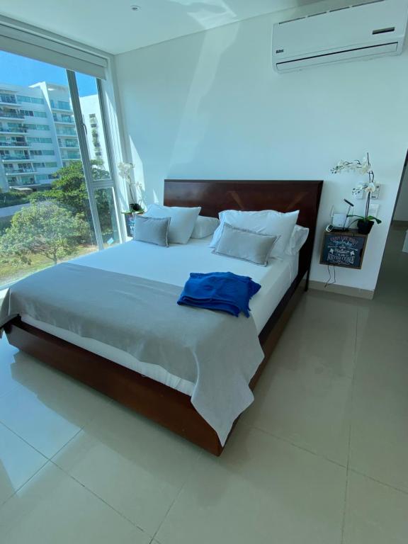 卡塔赫纳Playa -Boquilla -Condominio dentro de Hotel Sonesta的一间卧室设有一张大床和大窗户