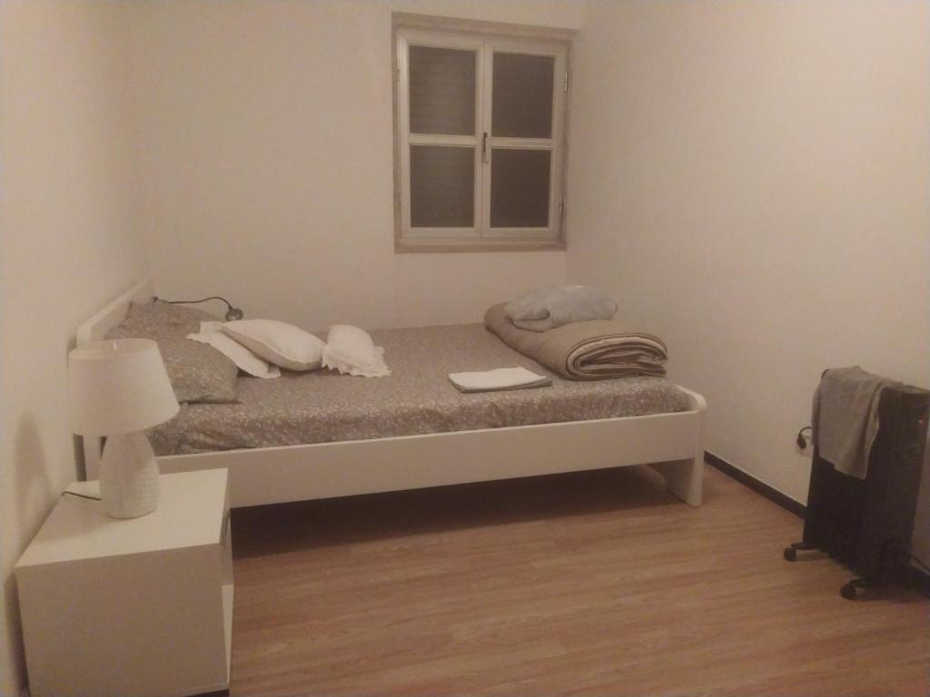 阿尔玛根Ginjals-67的卧室配有带枕头的床铺和窗户。