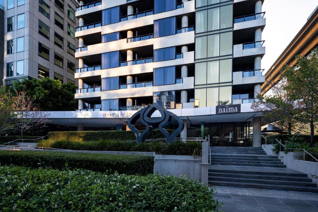 墨尔本Naima Hotel的前面有雕塑的建筑