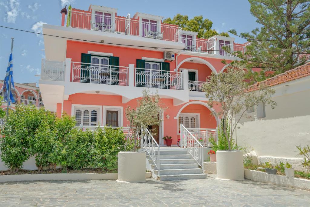 阿凯松Chryssa Studios的粉红色的建筑,前面有楼梯