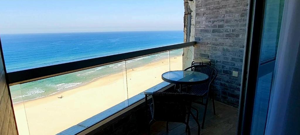 巴特亚姆Apart Hotel TLV/Bat Yam Beach Front 1207的一个带桌椅的海景阳台