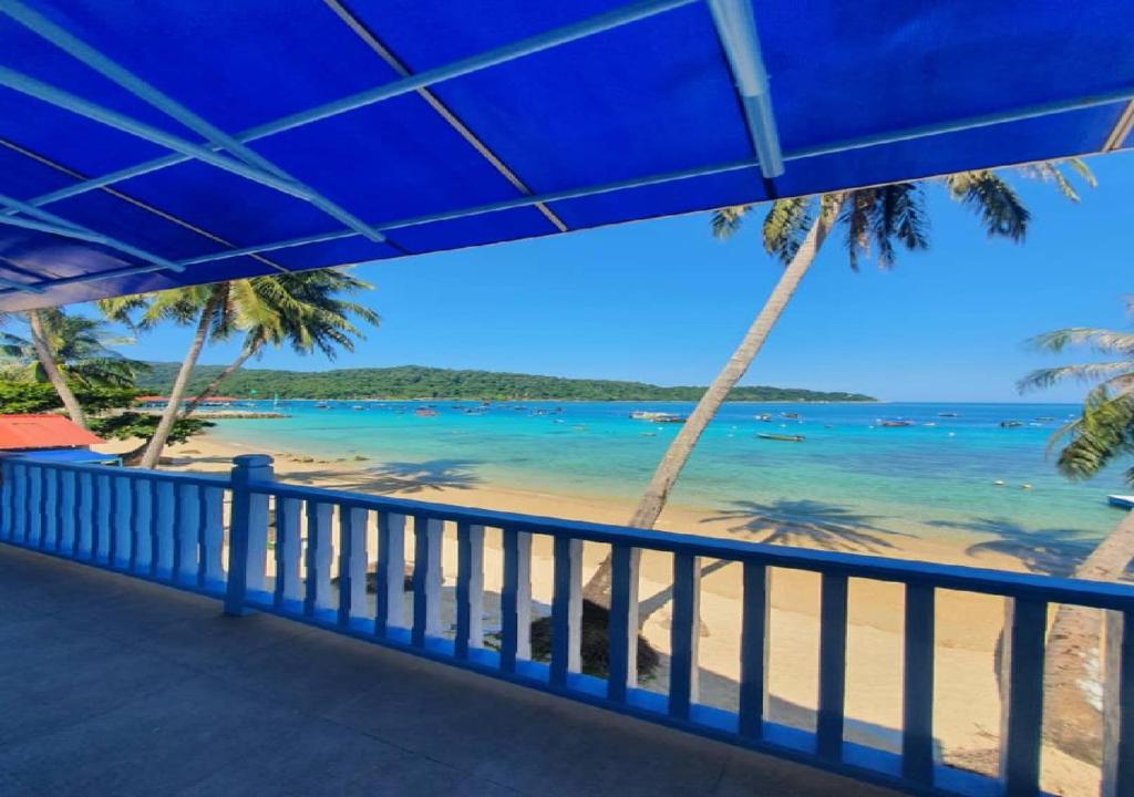 停泊岛Perhentian Bay Chalet的从度假村的阳台上可欣赏到海滩景色