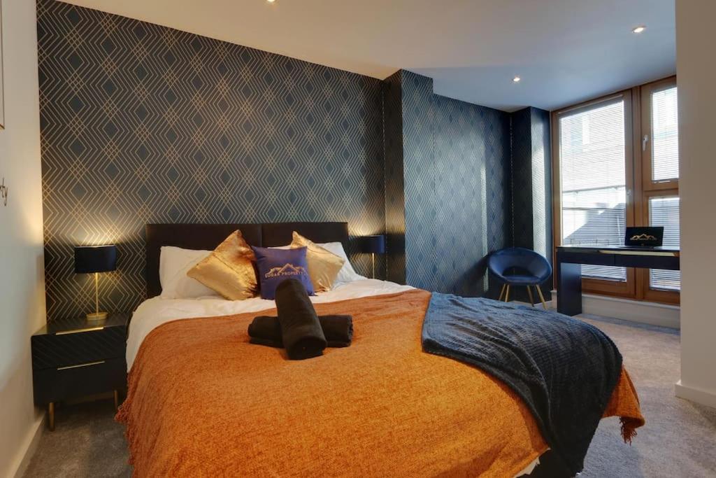谢菲尔德Home Away From Home - Contractors & Leisure的一间卧室配有一张带橙色毯子的大床