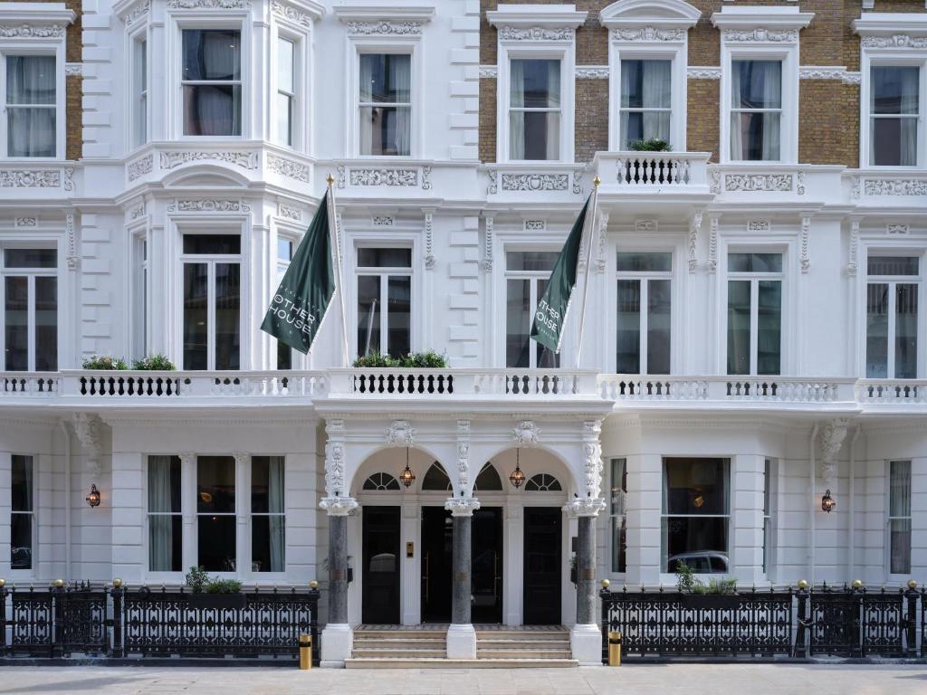伦敦The Other House South Kensington的前面有旗帜的白色建筑