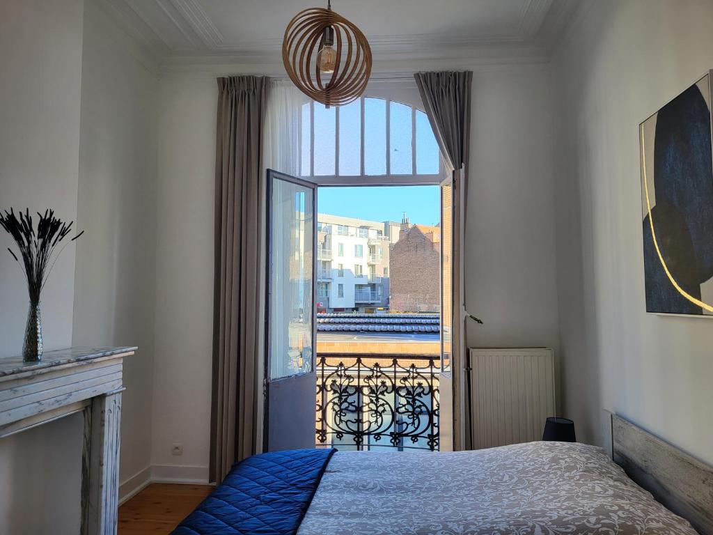 布鲁塞尔Brussels Bed & Blockchain Private rooms with shared bathroom的一间卧室设有一张床和一个大窗户