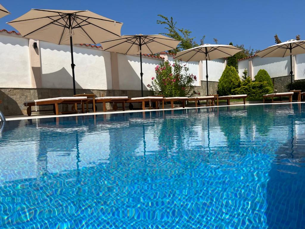 索佐波尔Villa Mia的一个带桌子和遮阳伞的大型游泳池