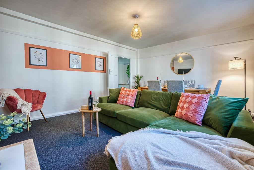 赛伦塞斯特Brewery Loft - 3 Bedroom Bright Spacious apartment in the centre of town, Wifi, Netflix的客厅配有绿色沙发和桌子