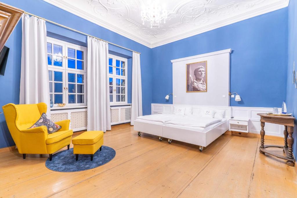 EllingenGasthof Römischer Kaiser的蓝色卧室,配有床和黄色椅子