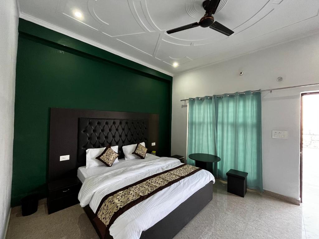LakhwārCorn village abode的一间卧室设有一张大床和绿色的墙壁