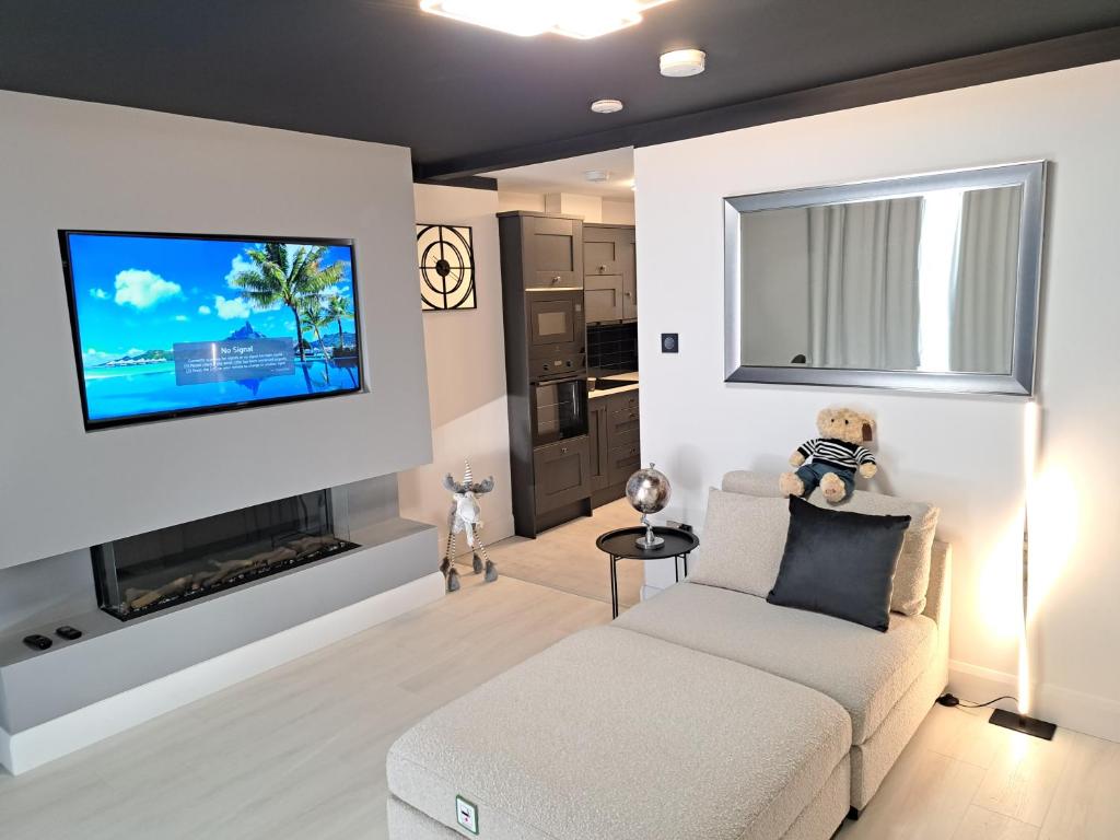 科芙SeaView Apartment Suite的客厅配有沙发和墙上的电视