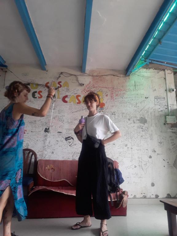 阿格拉Superinn home stay& guest house的两位女士正在画一堵房间里的房子
