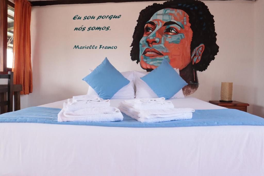 塔巴贝拉Hotel Venus de Valdivia Aeropuerto的一间房间,配有一张带一幅女性画的床