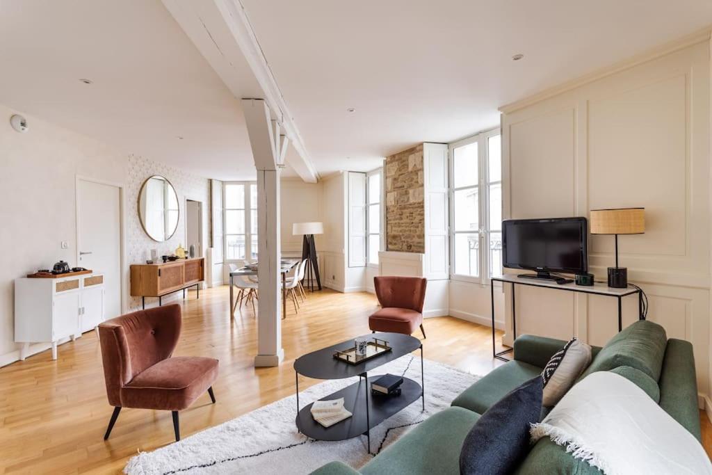 雷恩La Tourelle & l'Honoré - 2 appartements dans le Centre historique de Rennes的客厅配有沙发、椅子和电视