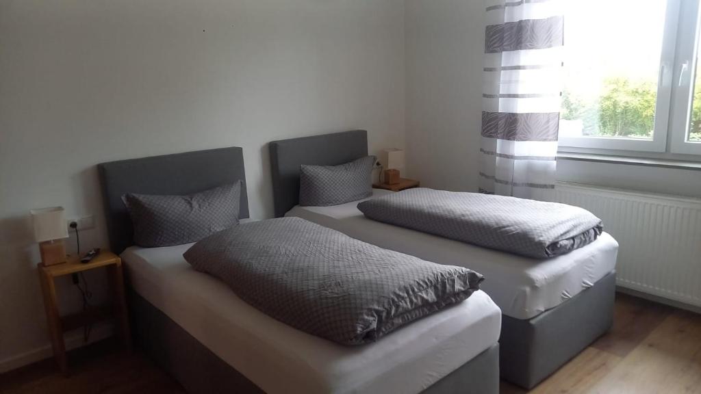 吉贝尔施塔特Katjas Ferienwohnungen的带窗户的客房内设有两张单人床。