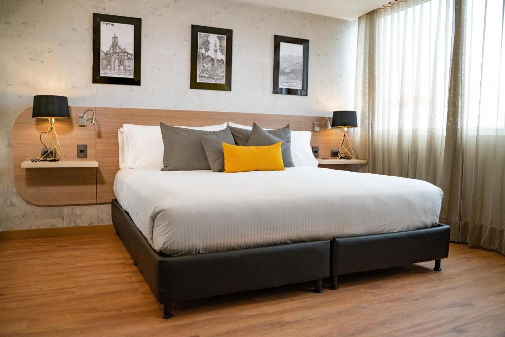 库库塔Hotel Casino Internacional的一间卧室配有一张带黄色枕头的大床