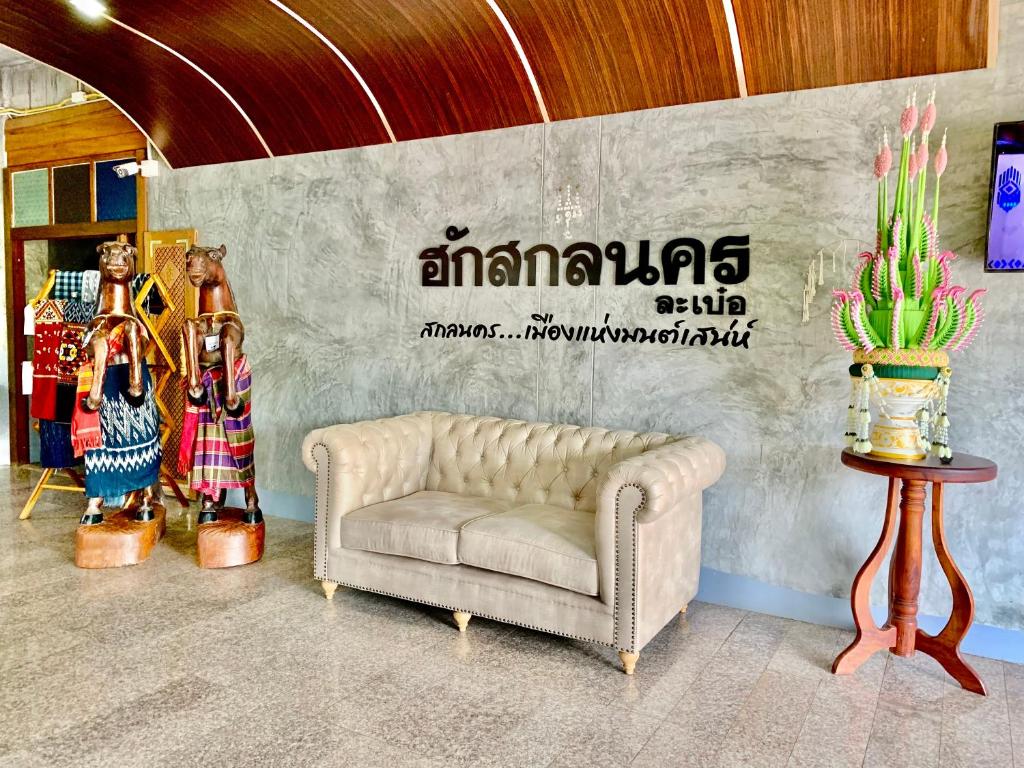 色军Hug Sakhonnakhon Hotel的客厅的墙上设有沙发