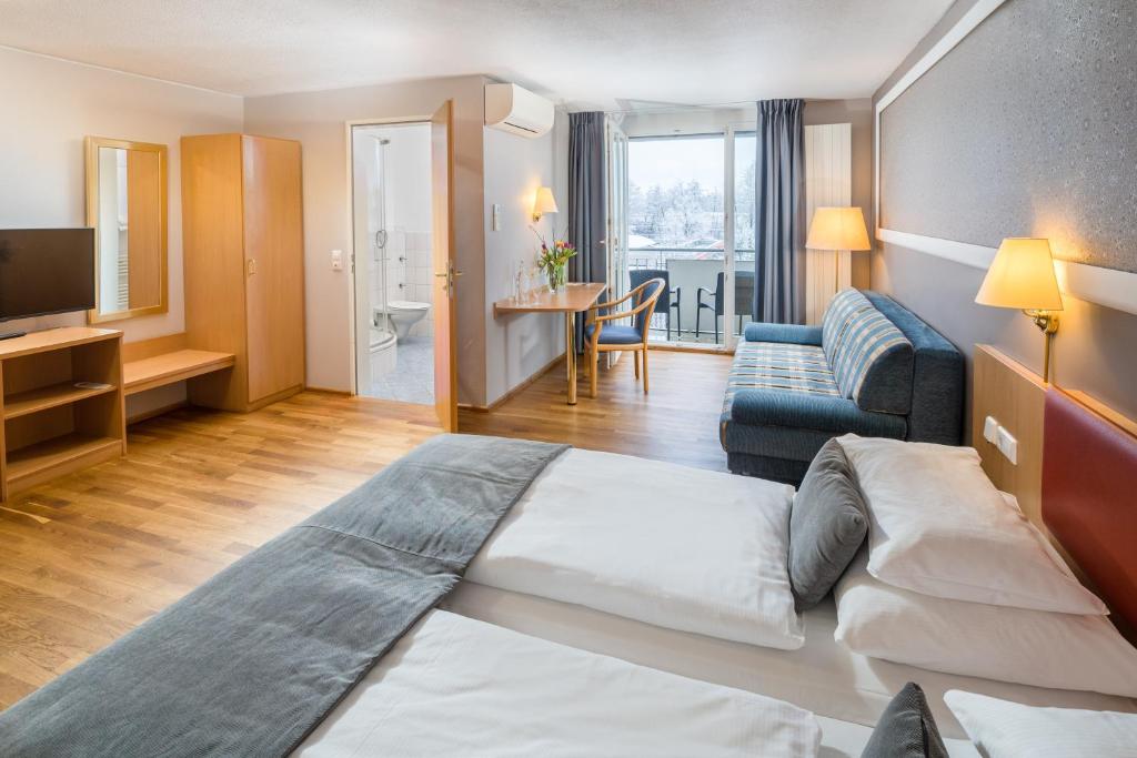 弗莱堡经典酒店的酒店客房设有床和客厅。