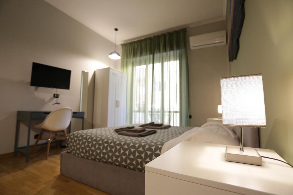 那不勒斯Vomero Maison的一间卧室配有一张床和一张带台灯的书桌