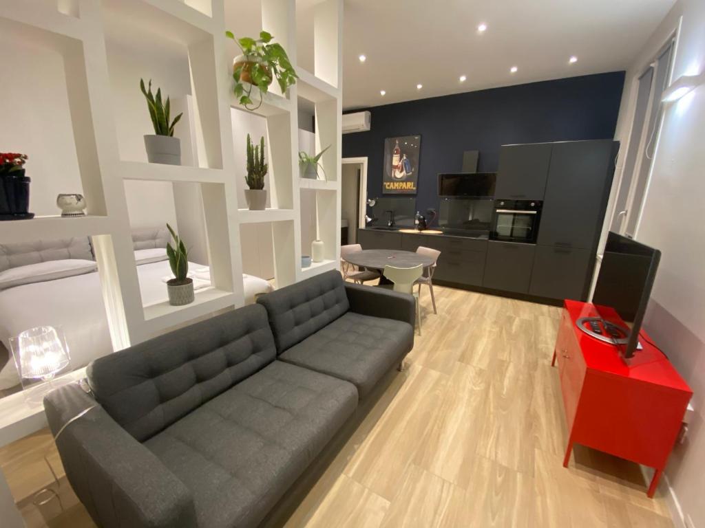 米兰#milanodabere Urban Loft的客厅配有灰色的沙发和红色的桌子