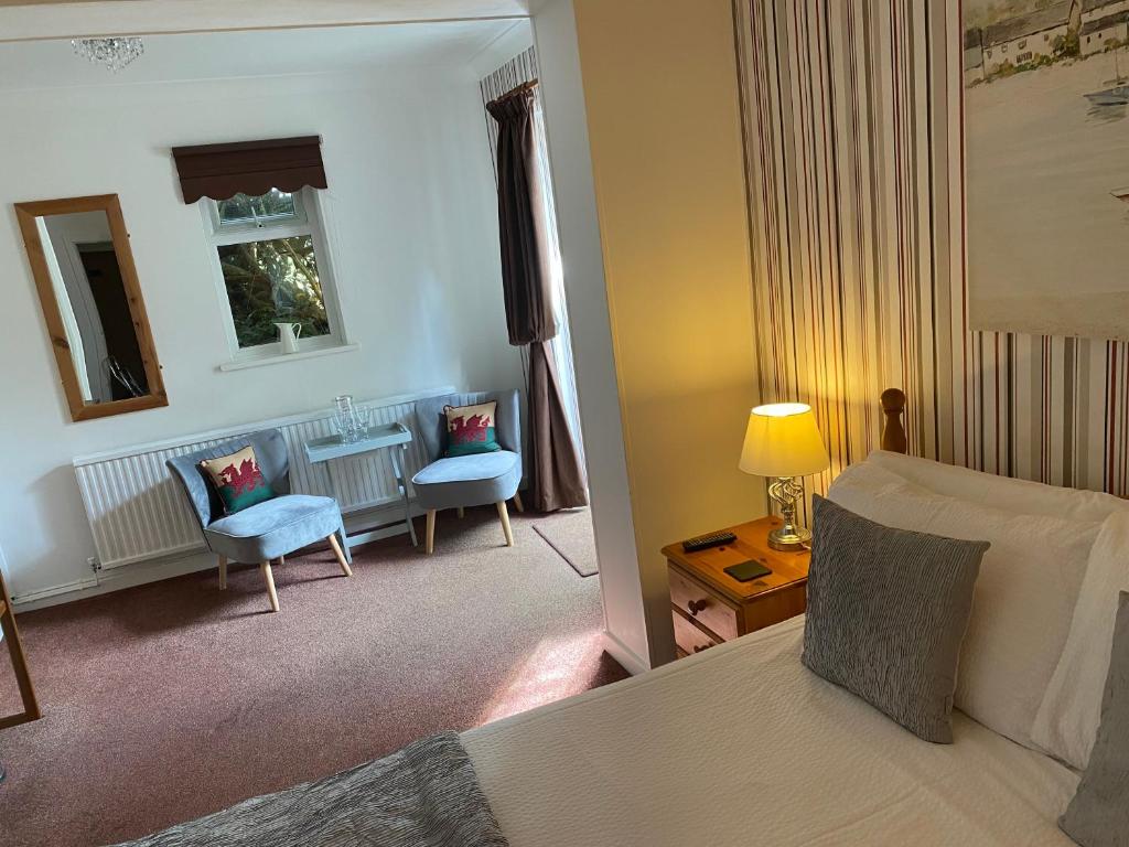 巴茅思塔利邦特住宿加早餐旅馆的配有一张床和一把椅子的酒店客房