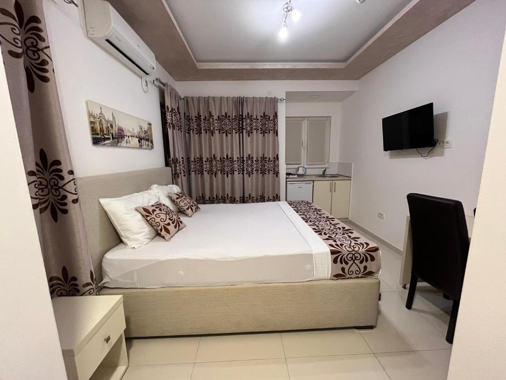 布德瓦Pearl Apartments的一间卧室配有一张床和一台电视