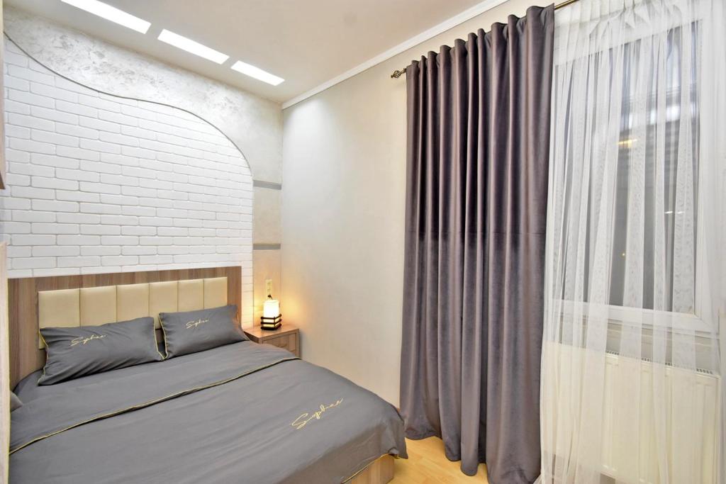埃里温Apart House in Yrevan Mashtots Avenue的一间卧室设有一张床和一个大窗户