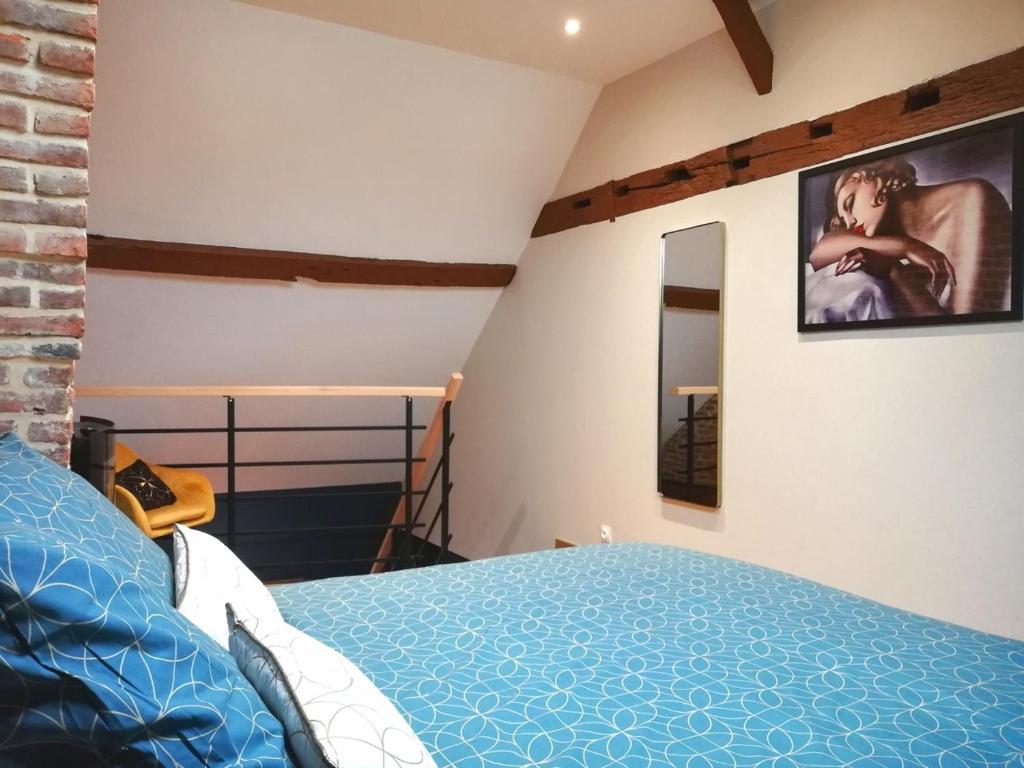 瓦朗西纳Calme/ Confortable / Esthétique / Centre-ville的卧室配有一张床,墙上配有电视。