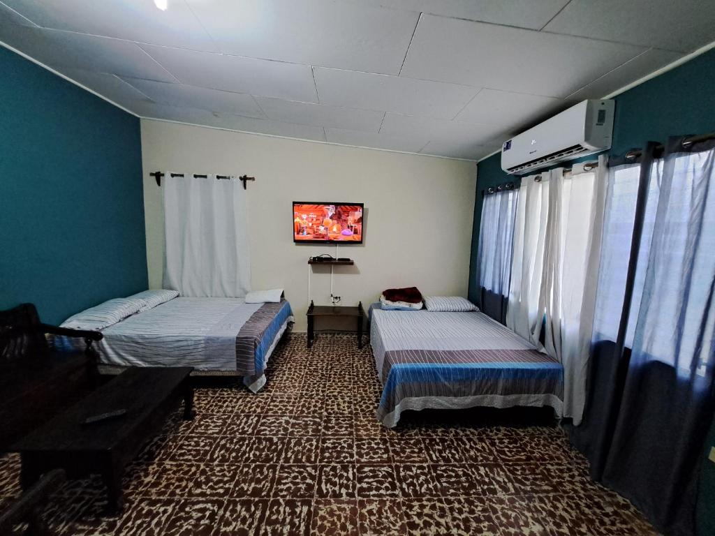 La LimaHostal Lima Verde的一间设有两张床和钢琴的房间
